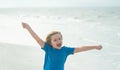 Happy boy enjoys run on beach. Amazed child face. Expressive emotional. Summer portrait of child excited run. Summer