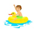 Happy boy floating on inflatable duck inner ring tube Royalty Free Stock Photo