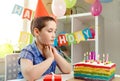 Happy boy with funny face near birthday cake. Birthday party and cake Royalty Free Stock Photo