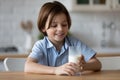 Happy boy with funny white moustache drinking milk Royalty Free Stock Photo