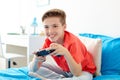 Happy boy with gamepad playing video game at home Royalty Free Stock Photo