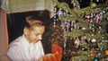 1954: Happy boy gets baseball glove for Christmas gift. NEWARK, NEW JERSEY