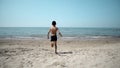 Boy child running towards the sea