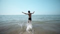 Happy boy getting int the sea water