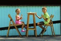 Happy boy and girl, brother and sister, eating ice cream in the open air outdoor sidewalk city cafe