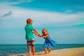 Happy boy and girl dance at beach, kids enjoy vacation Royalty Free Stock Photo