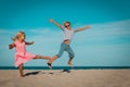 Happy boy and girl dance at beach, kids enjoy vacation Royalty Free Stock Photo