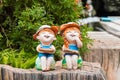 Happy boy and girl dolls made from baked clay decorative in a garden