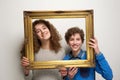 Happy boy and girl holding picture frame Royalty Free Stock Photo