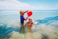 Happy boy and girl play on beach, kids splash water and have fun Royalty Free Stock Photo