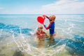 Happy boy and girl play on beach, kids splash water and have fun Royalty Free Stock Photo