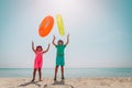 Happy boy and girl play with floaties on beach vacation Royalty Free Stock Photo