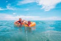 Happy boy and girl play with water guns while floating on beach Royalty Free Stock Photo