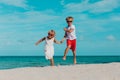 Happy boy and girl run at beach, kids play on vacation Royalty Free Stock Photo