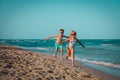 Happy boy and girl run play at beach Royalty Free Stock Photo