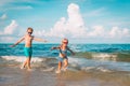 Happy boy and girl run play at beach Royalty Free Stock Photo