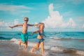 Happy boy and girl run play at beach Royalty Free Stock Photo