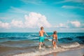 Happy boy and girl run play at beach Royalty Free Stock Photo