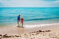 Happy boy and girl run and play with water on beach Royalty Free Stock Photo