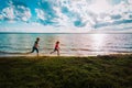 happy boy and girl run at sunset beach, kids have fun Royalty Free Stock Photo