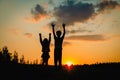 Happy boy and girl silhouettes enjoy sunset nature Royalty Free Stock Photo