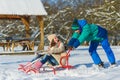 Happy boy and girl sledding in winter outdoor Royalty Free Stock Photo