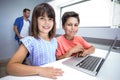 Happy boy and girl using laptop Royalty Free Stock Photo