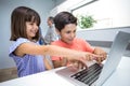 Happy boy and girl using laptop Royalty Free Stock Photo