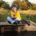 Happy boy go fishing on the river, one child of the fisherman with a fishing rod on the shore of lake Royalty Free Stock Photo