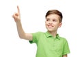 Happy boy in green polo t-shirt pointing finger up Royalty Free Stock Photo