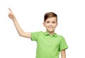 Happy boy in green polo t-shirt pointing finger up Royalty Free Stock Photo