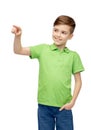 Happy boy in green polo t-shirt pointing finger up Royalty Free Stock Photo