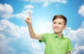 Happy boy in green polo t-shirt pointing finger up Royalty Free Stock Photo