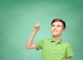 Happy boy in green polo t-shirt pointing finger up Royalty Free Stock Photo