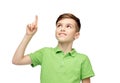 Happy boy in green polo t-shirt pointing finger up Royalty Free Stock Photo