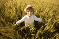 Happy boy with hat in the middle of wheat field Royalty Free Stock Photo