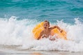 Happy boy have fun in sea surf on beach