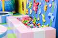 Happy boy having fun in ball pit in kids amusement park and indoor play center. Child playing with colorful balls in playground Royalty Free Stock Photo