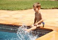 Happy boy having fun at swimming pool Royalty Free Stock Photo