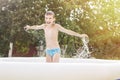 Happy boy having fun in the swimming pool with father in the garden at summer Royalty Free Stock Photo
