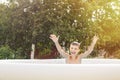Happy boy having fun in the swimming pool with father in the garden at summer Royalty Free Stock Photo