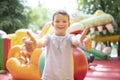 Happy boy having a lots of fun on a colorful inflate castle. Colorful playground. Activity and play center for kids Royalty Free Stock Photo