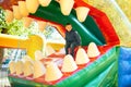 Happy boy having a lots of fun on a colorful inflate castle Royalty Free Stock Photo