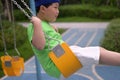 A boy with a headband have a ride on a swing Royalty Free Stock Photo