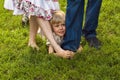 Happy boy hiding in parents legs Royalty Free Stock Photo