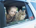 Happy boy and his companion cat in the car Royalty Free Stock Photo