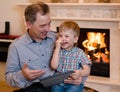 Happy boy and his grandfather using a tablet computer Royalty Free Stock Photo