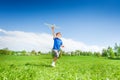 Happy boy holding airplane toy during running Royalty Free Stock Photo