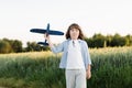 Happy boy holding airplane toy during running Royalty Free Stock Photo