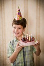 Happy boy holding a birthday cake Royalty Free Stock Photo